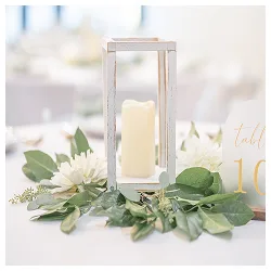 Candle lantern and greenery centerpieces